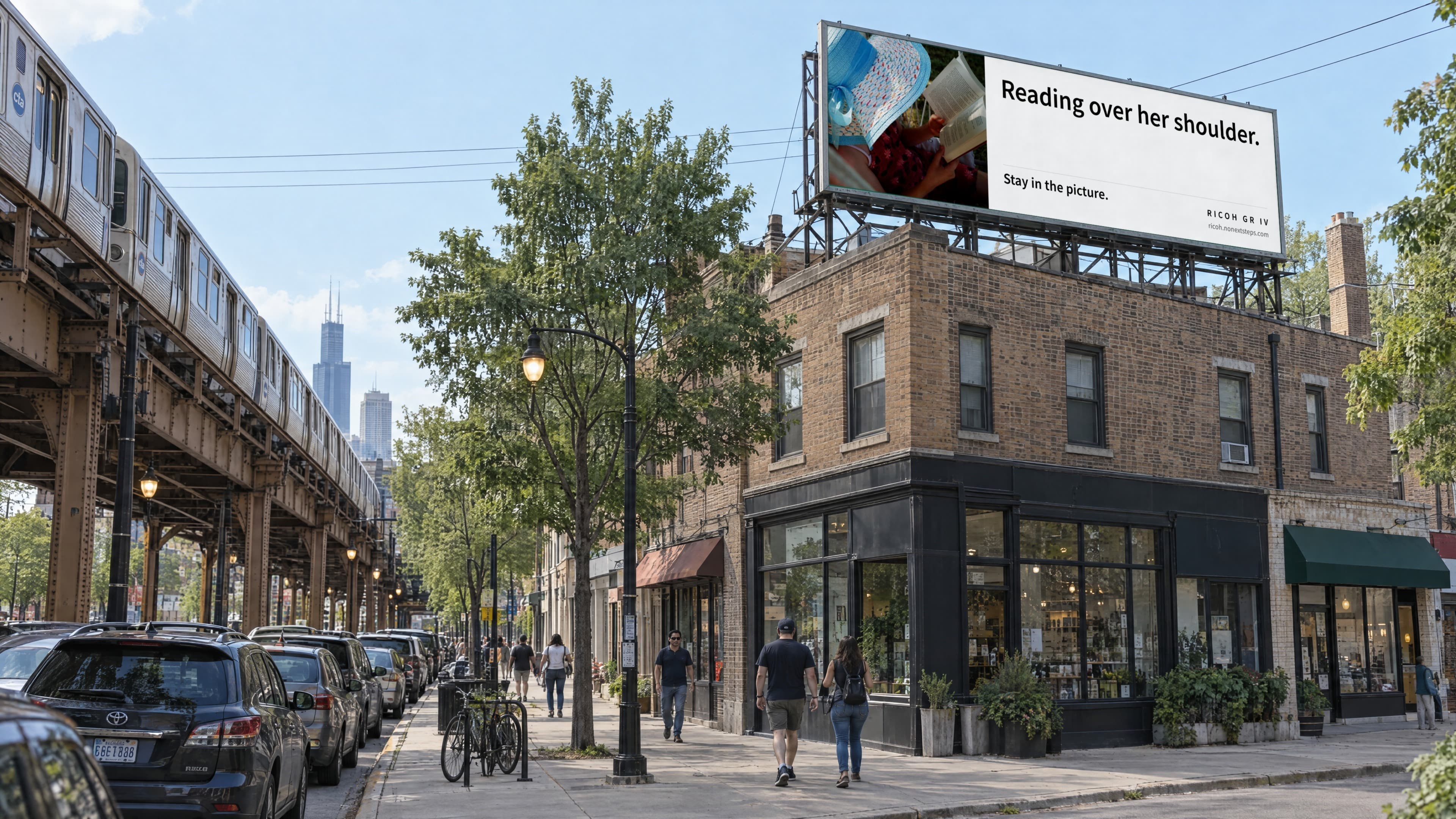 A rooftop billboard over a Chicago corner by the L tracks: a child reading under a sun hat, with the line Reading over her shoulder.